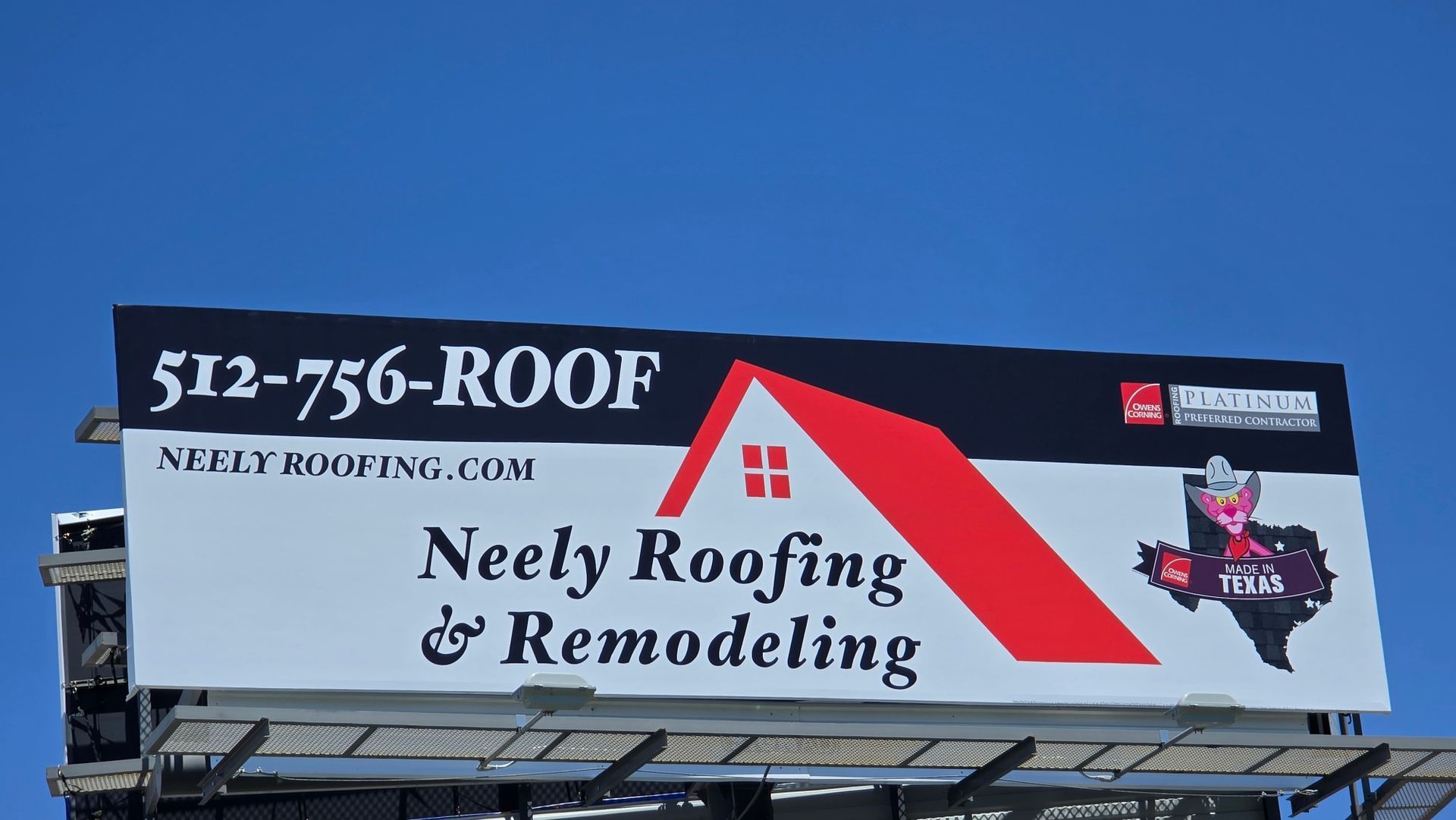 Billboard for Neely Roofing & Remodeling with 512-756-ROOF against a blue sky