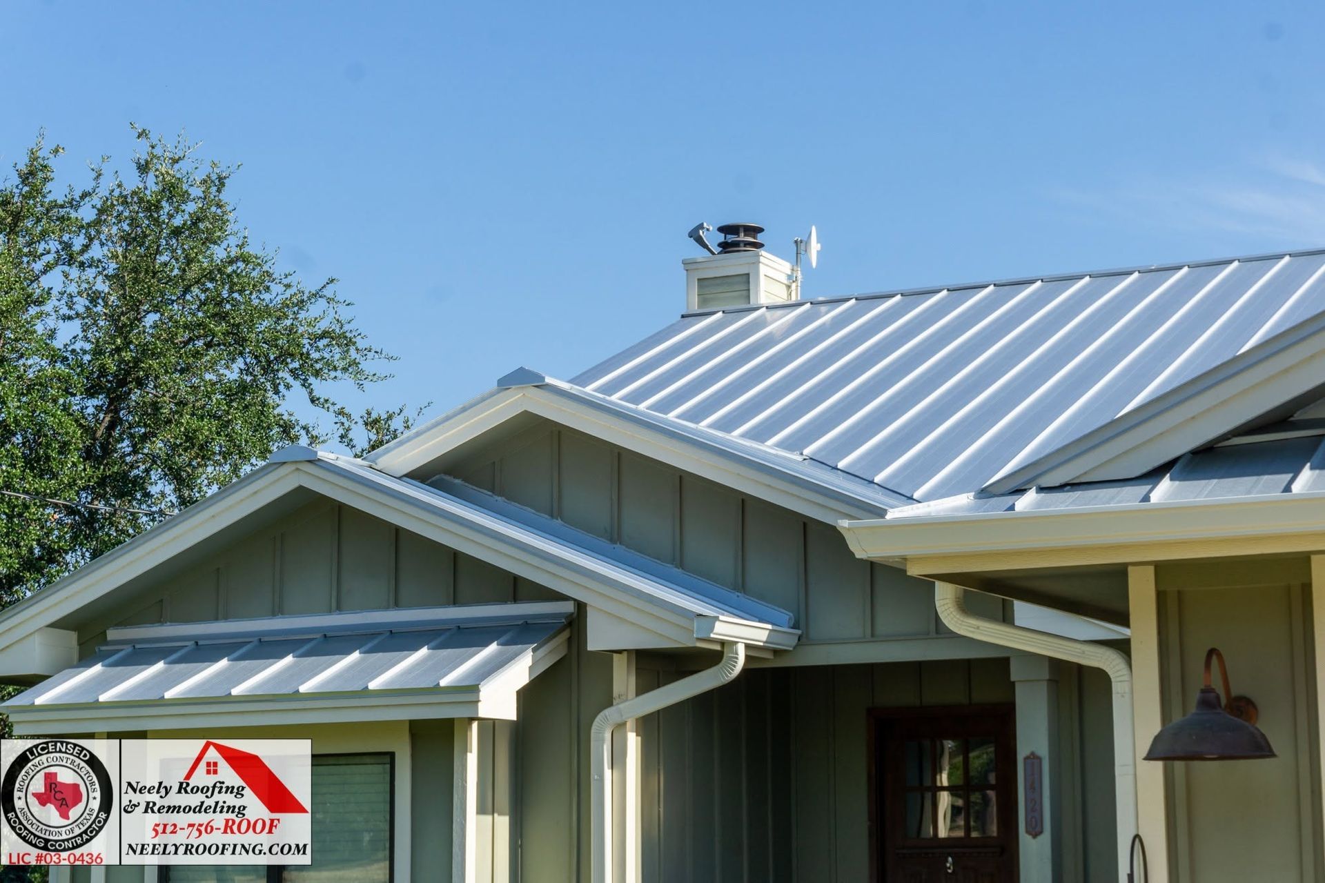 House with metal roof and red cross sign on the porch
