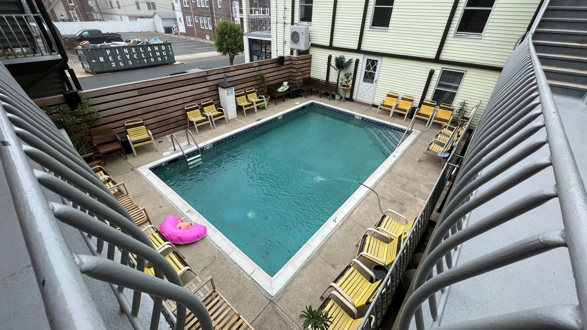 An aerial view of a large swimming pool surrounded by chairs