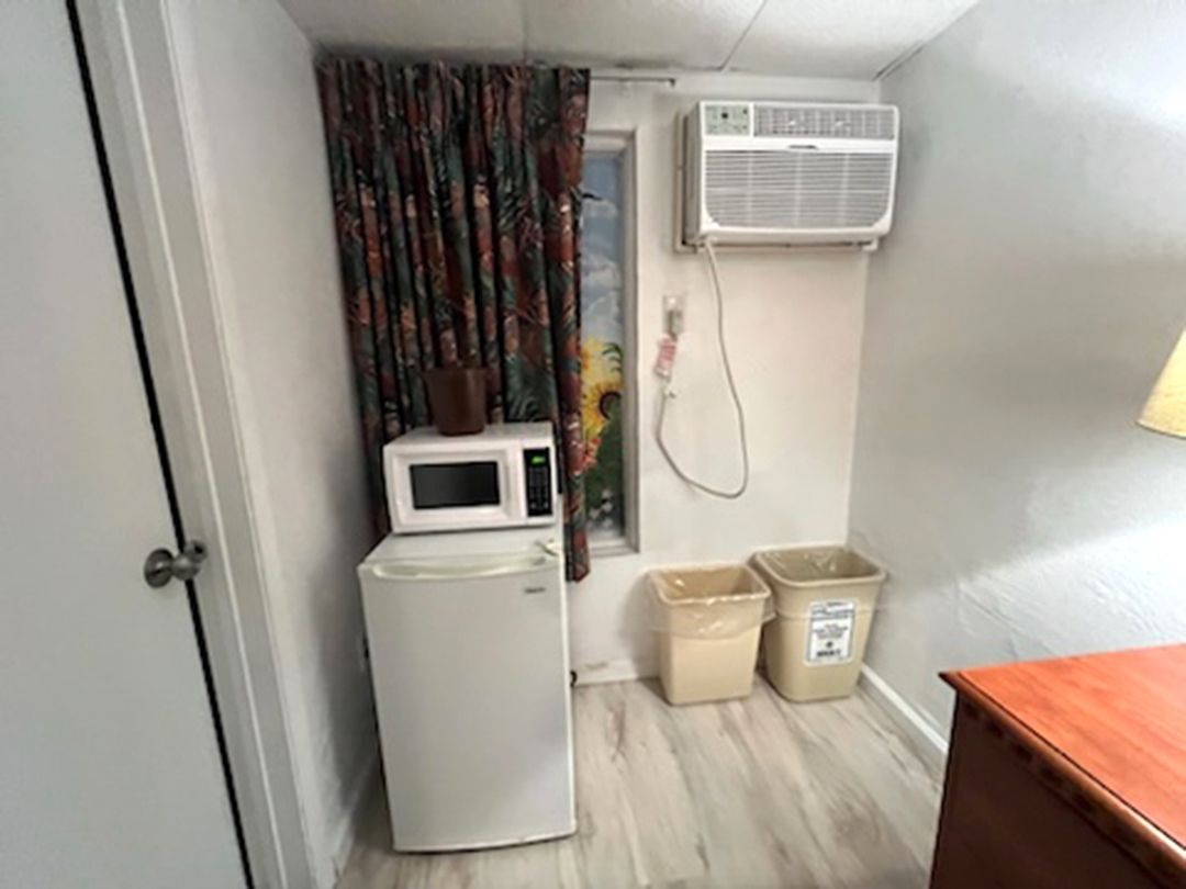 There is a microwave and a refrigerator in the room.