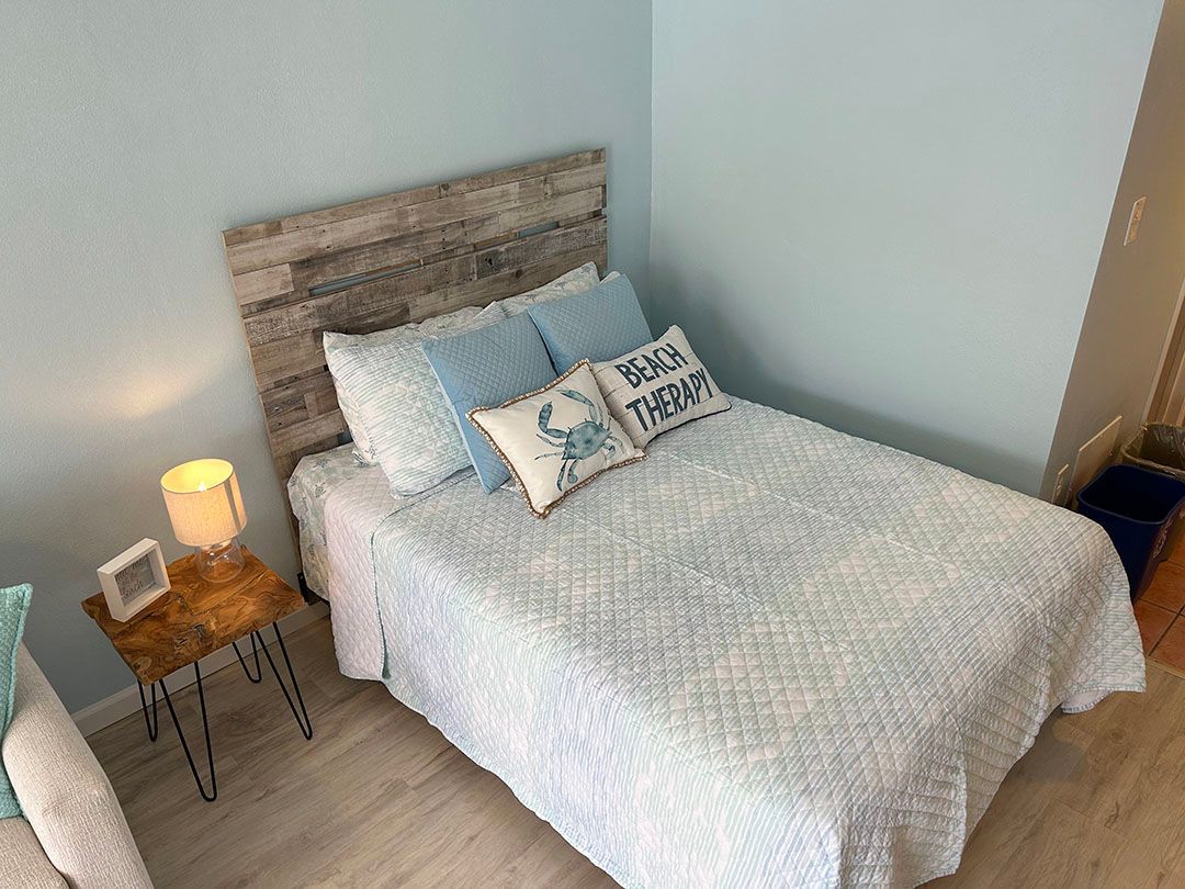 A bed with a wooden headboard and pillows