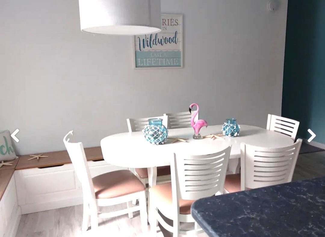 A dining room with a table and chairs and a flamingo on the table