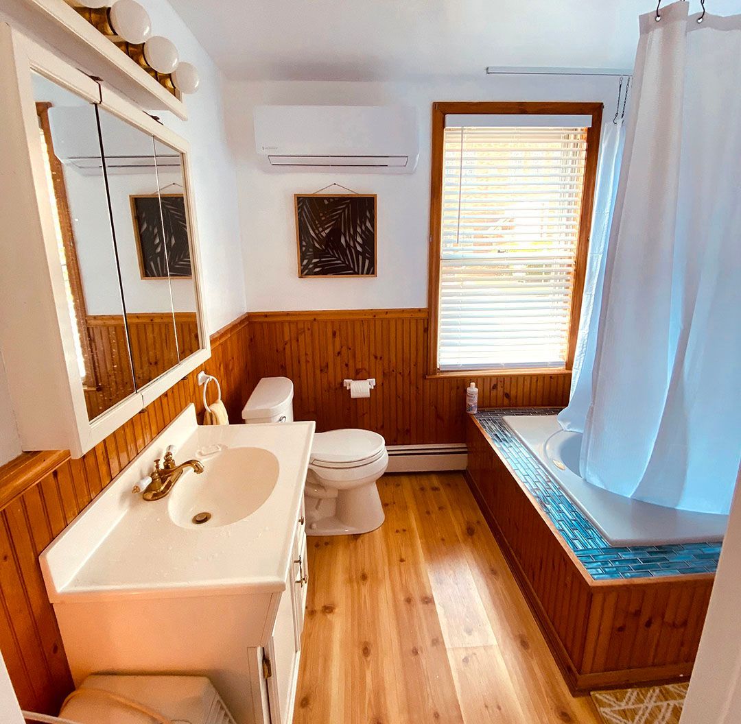 A bathroom with a sink a toilet and a bathtub