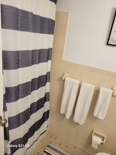 A bathroom with a shower curtain that says galaxy on it