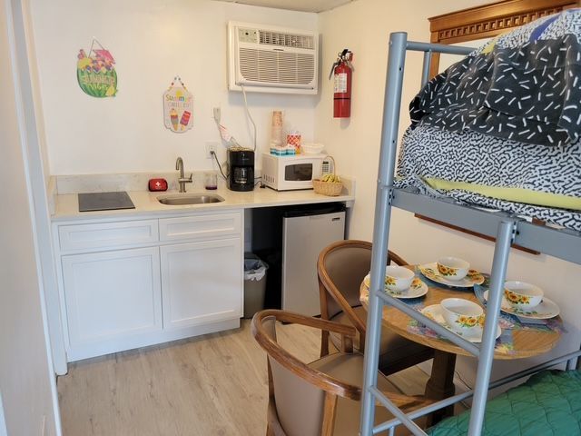 A kitchen with a bunk bed and a table