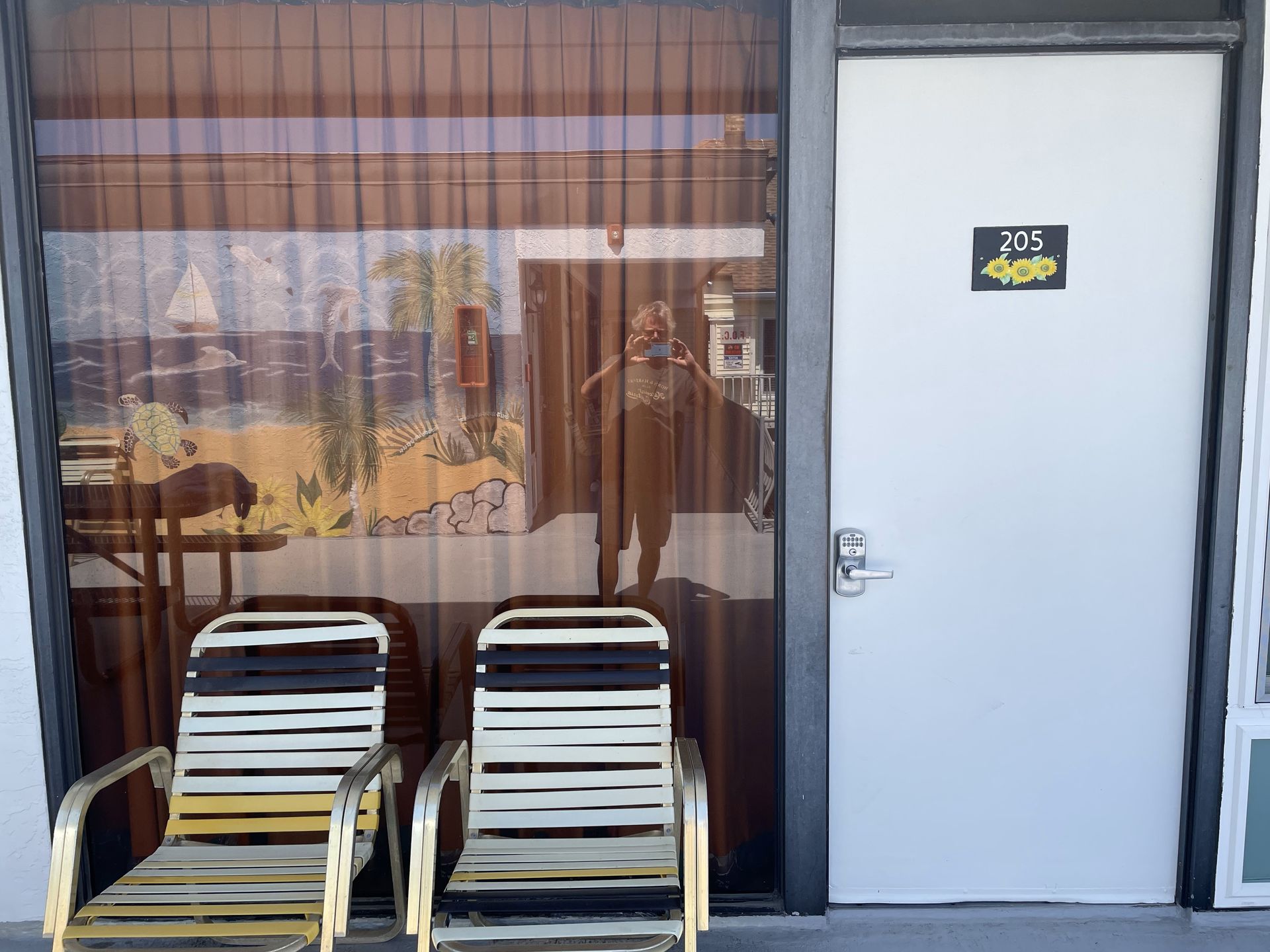 Two chairs are in front of a door that says 895