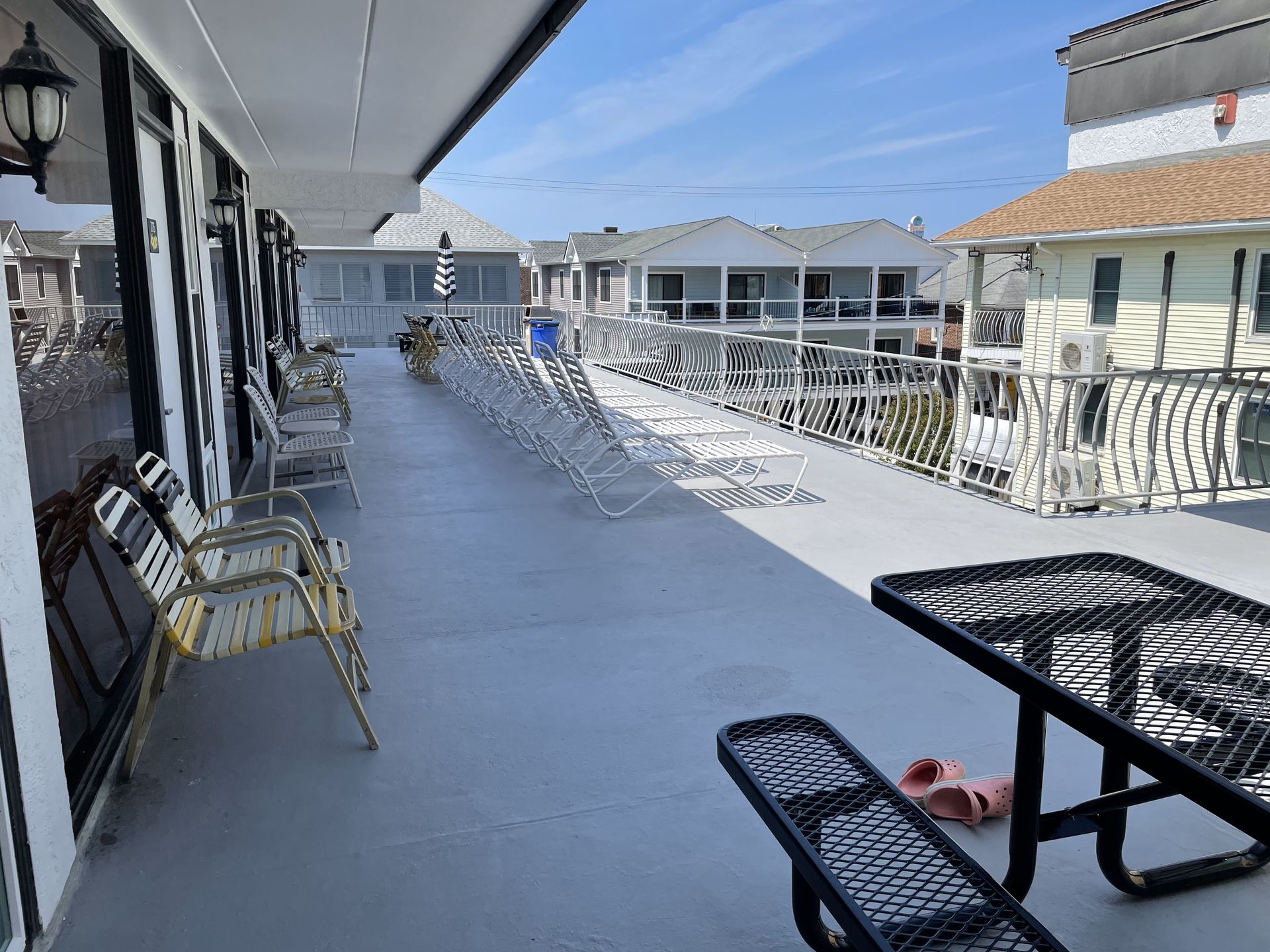 A large deck with a picnic table and chairs