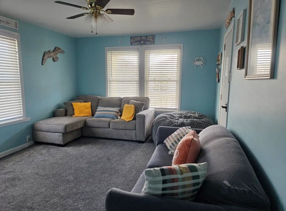 A living room with a couch and a ceiling fan
