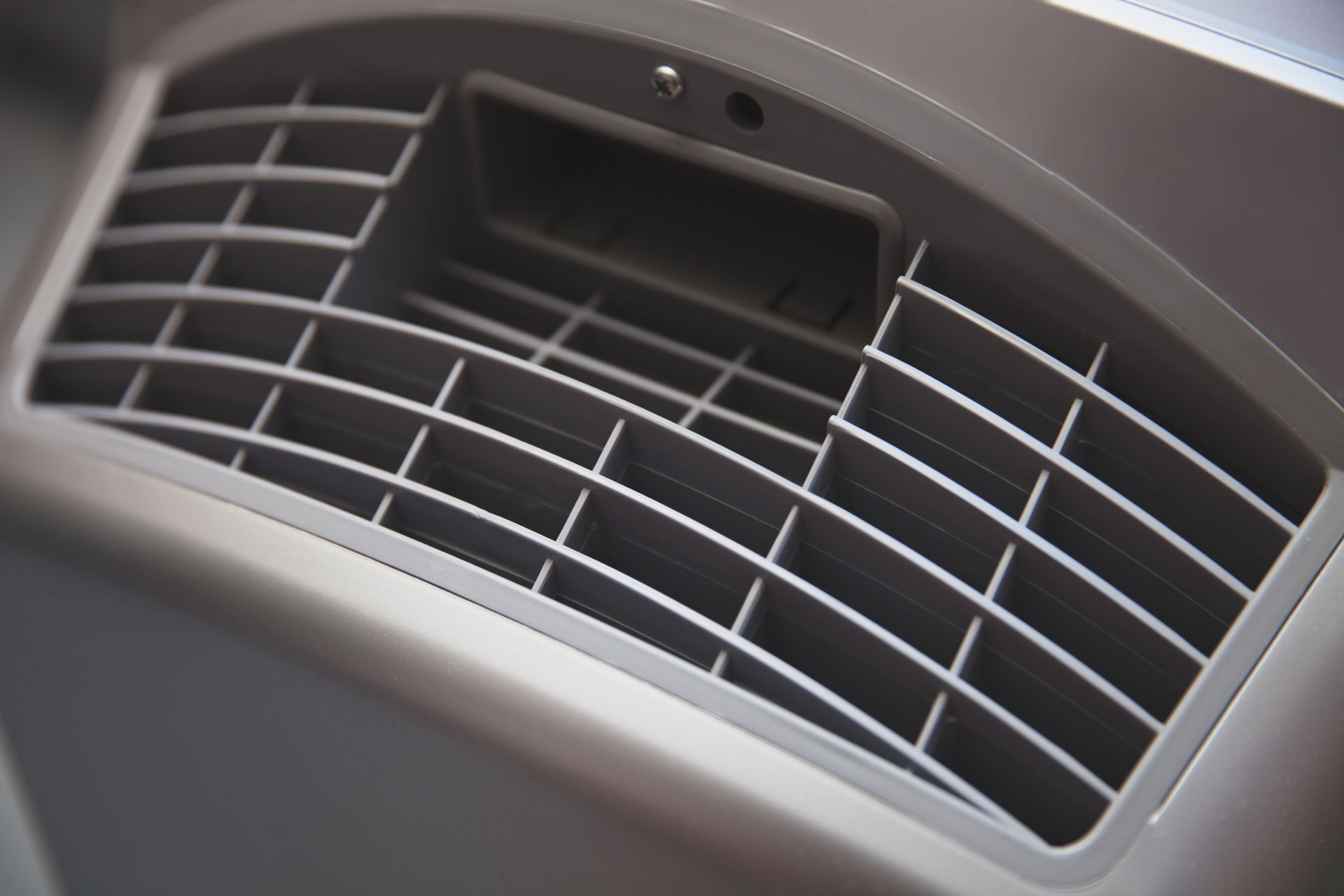 Close-up of a silver air vent with a rectangular opening in the center.