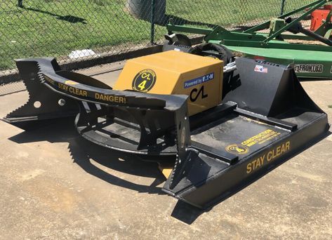 A machine that says stay clear on it is sitting on the ground.