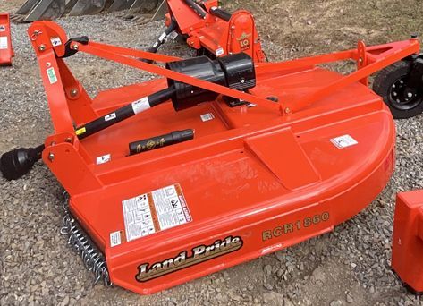 Orange Land Pride rotary cutter mower, used outdoors.