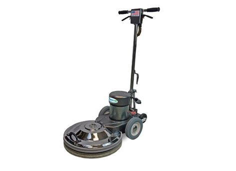 A floor polisher is sitting on a white surface.