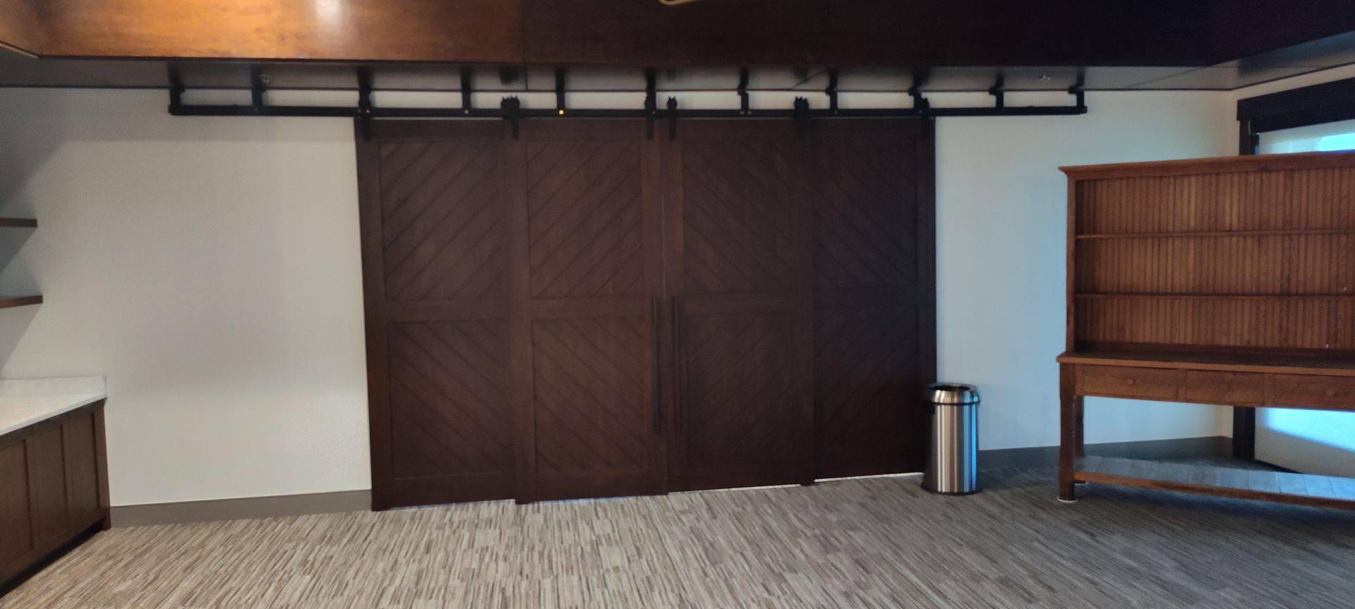 There is a sliding barn door in the middle of the room.