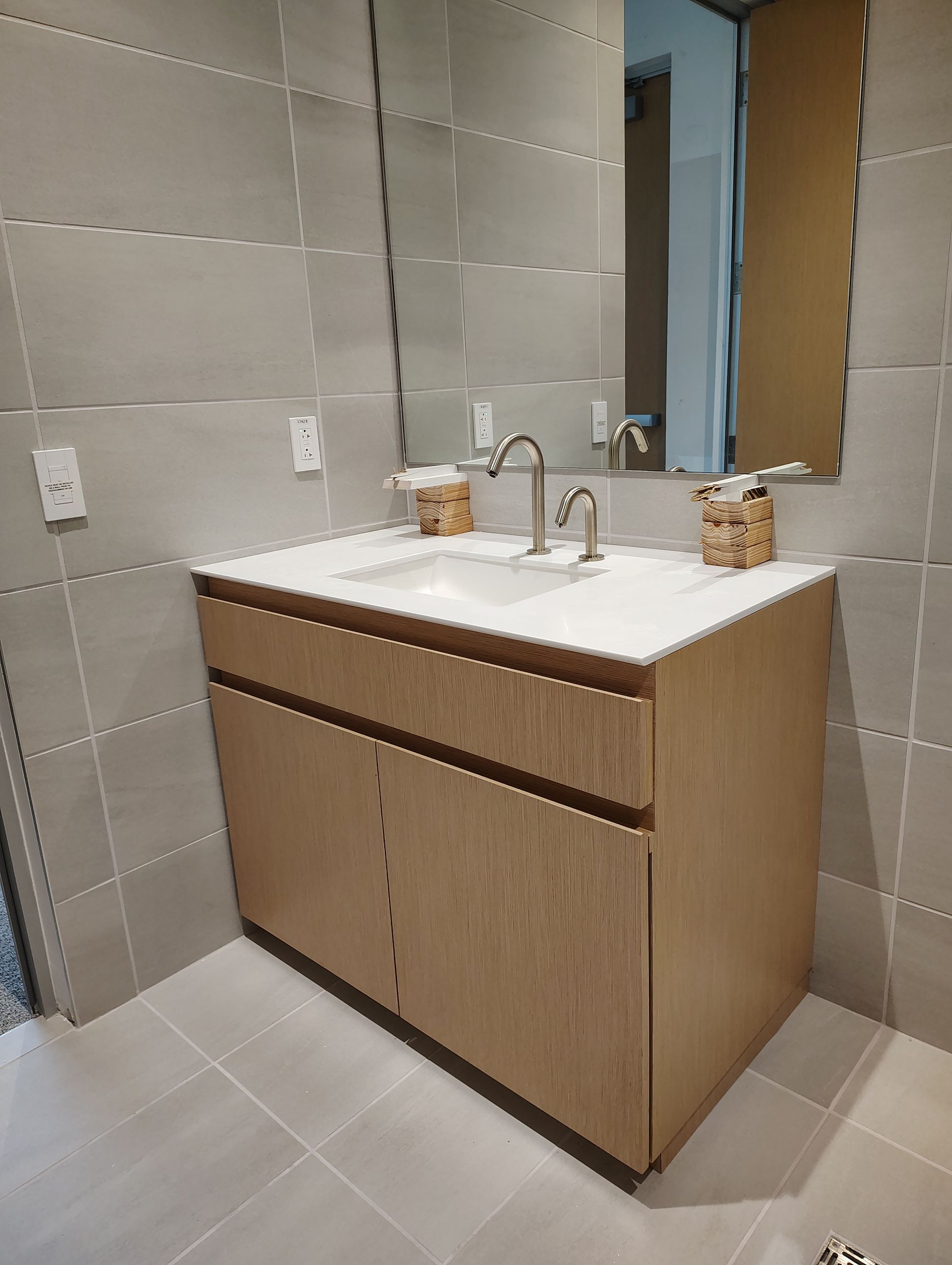 A bathroom with two sinks and a mirror.