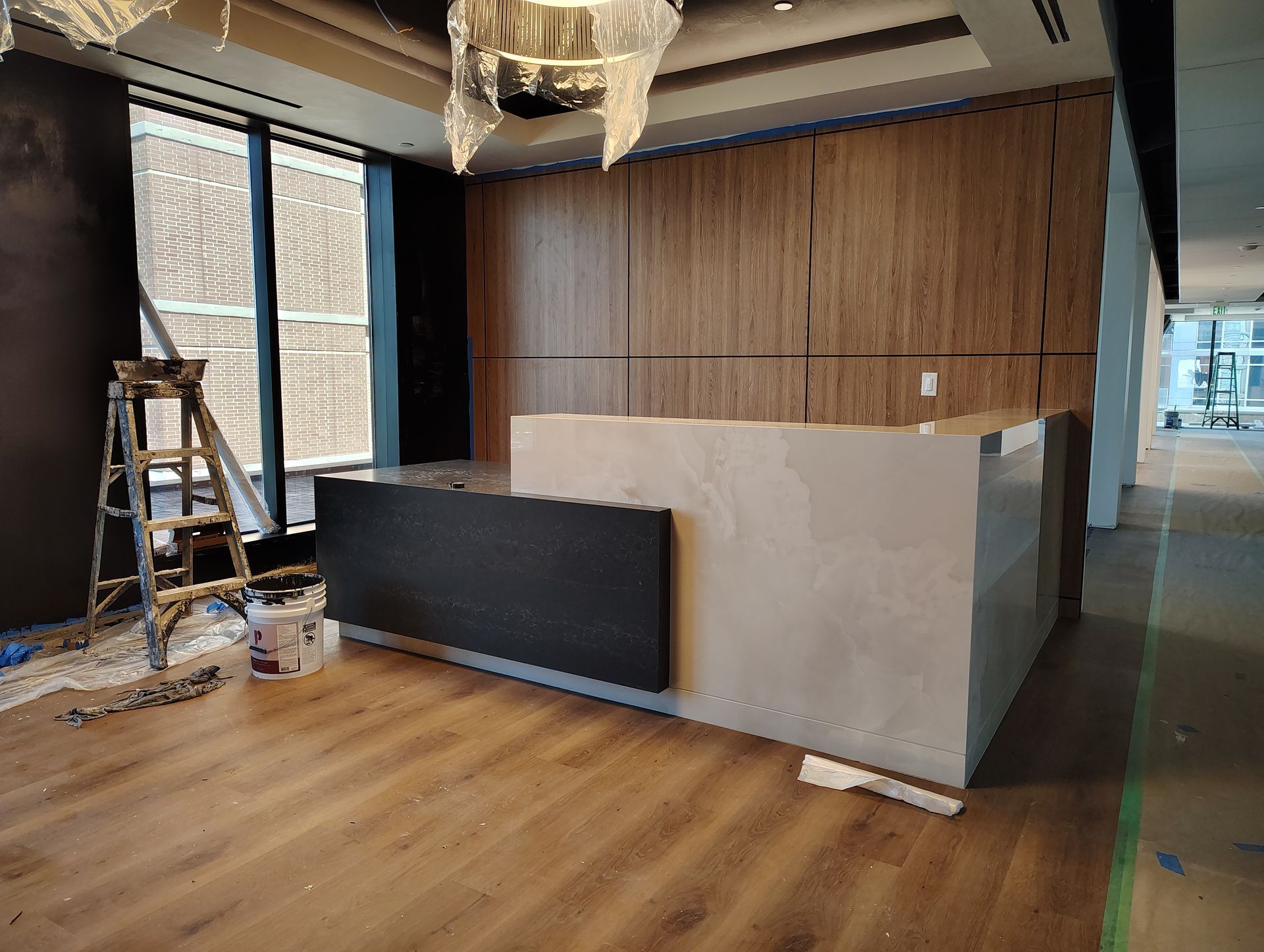 There is a ladder in the middle of the room next to a reception desk.