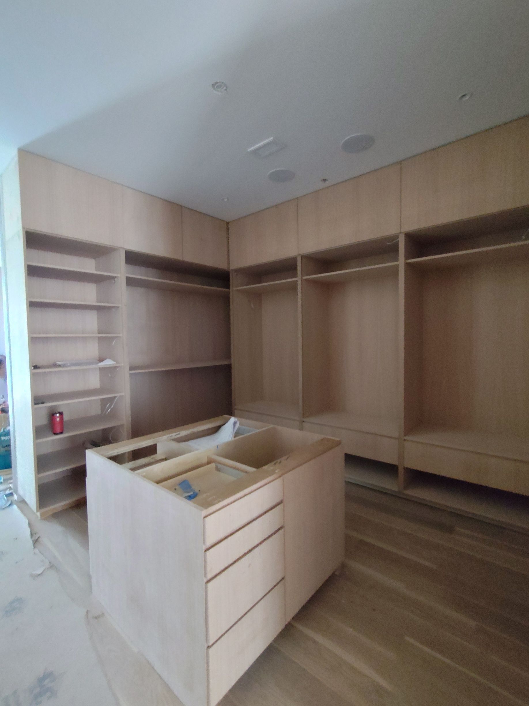 A large closet with lots of shelves and drawers.