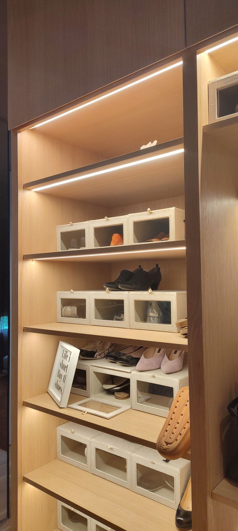 A closet filled with lots of shoes and boxes.