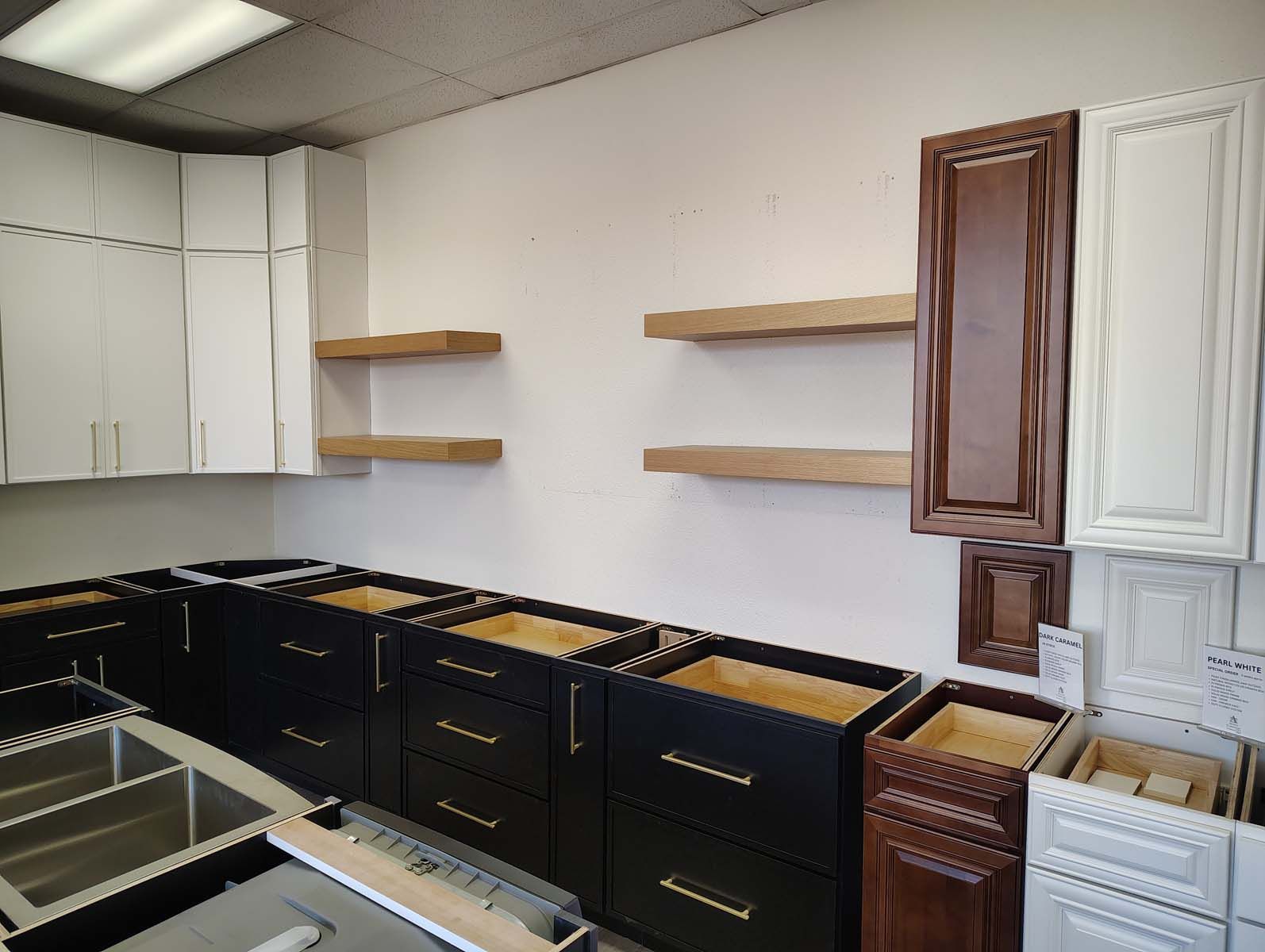 A kitchen with black and white cabinets and a sink.