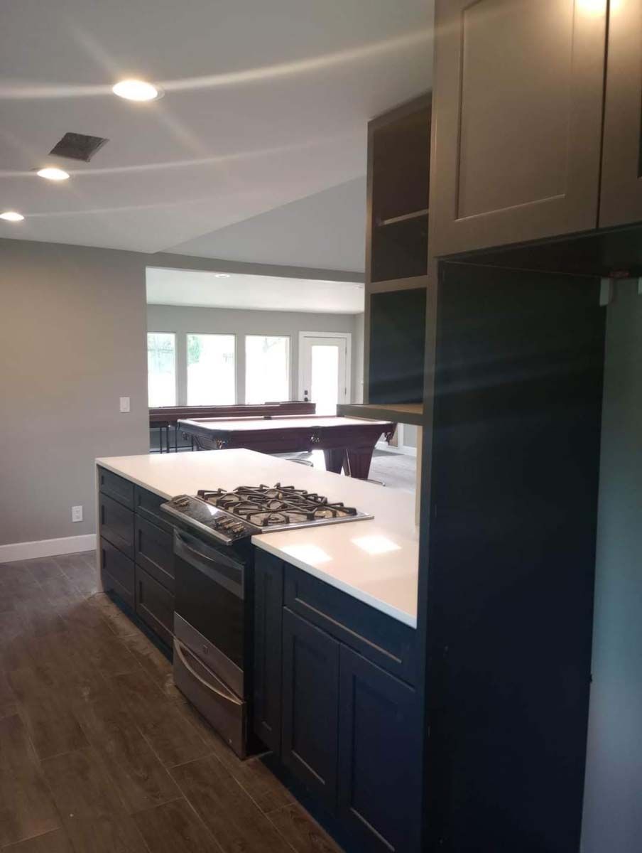 A kitchen with a stove top oven and a refrigerator.