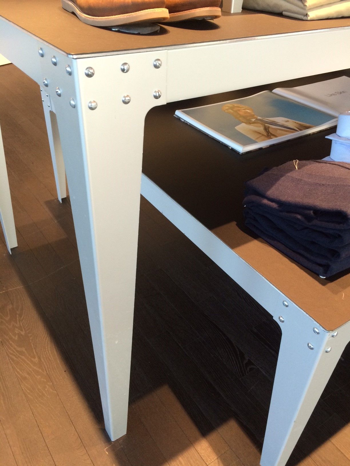 A table with a stack of blankets on it.