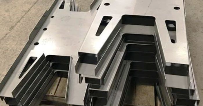 A stack of metal pieces sitting on top of each other on a wooden table.