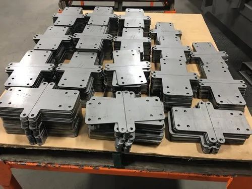 A stack of metal pieces sitting on top of a wooden table.