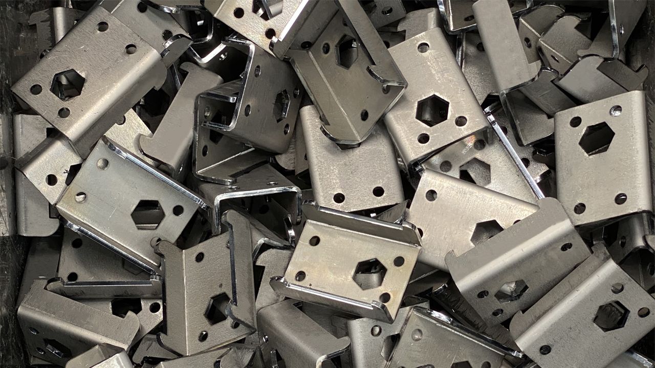 A pile of metal pieces with holes in them.