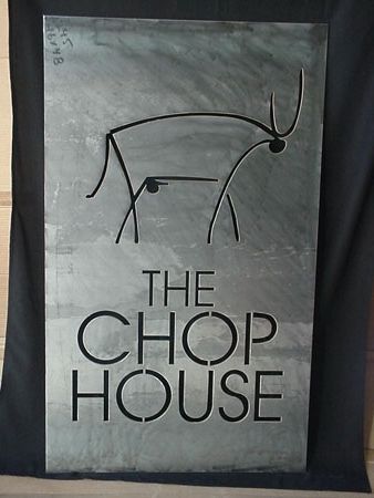 A sign for the chop house has a picture of a deer on it.