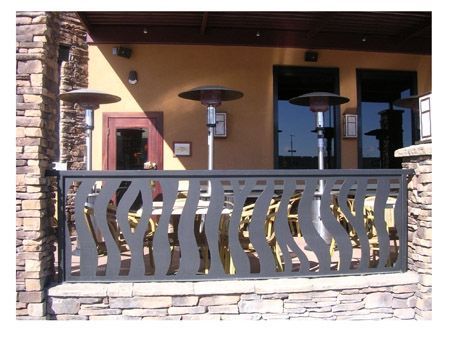 A balcony with a metal railing and heaters on it.
