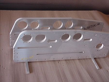 A piece of metal with holes in it is sitting on a table.