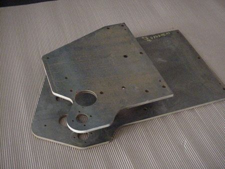 Two metal plates are stacked on top of each other on a table.