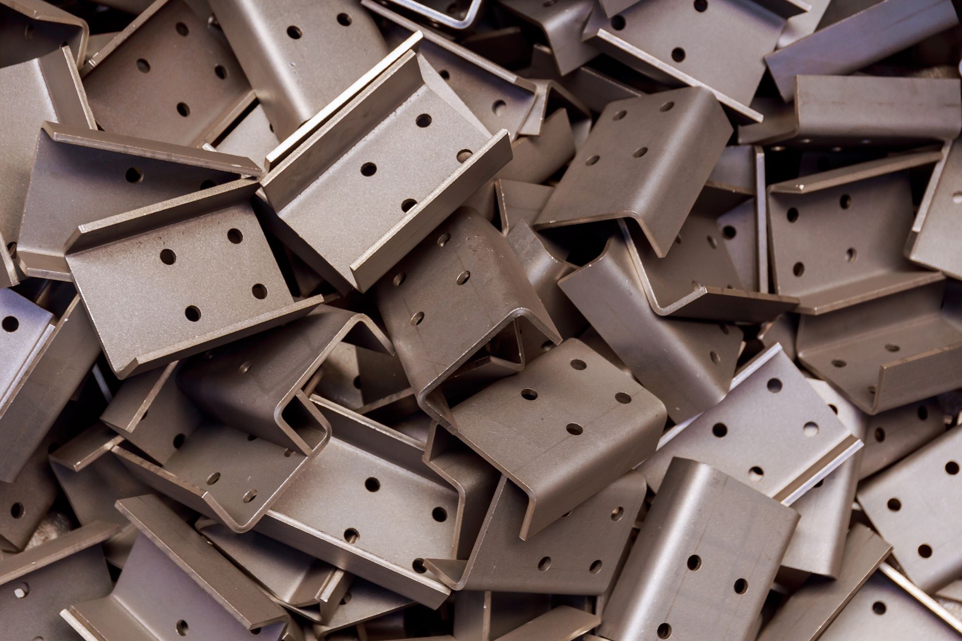 A pile of metal pieces with holes in them.