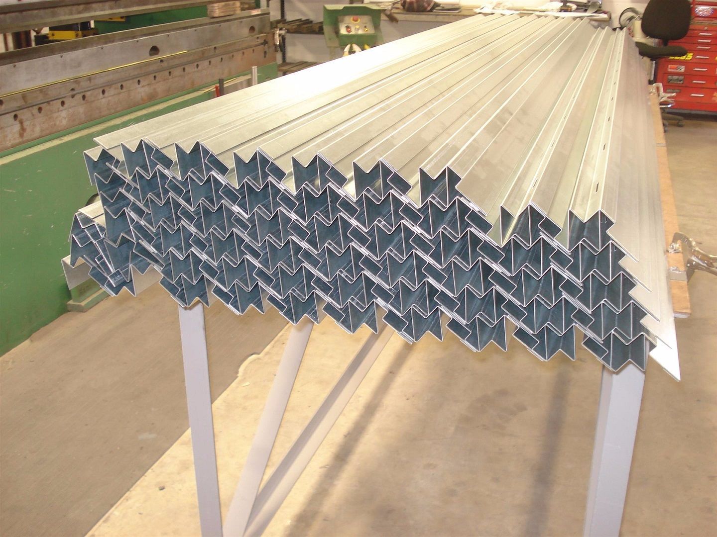 A bunch of metal tubes are stacked on top of each other.