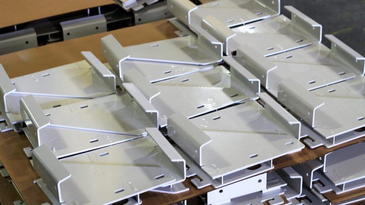 A bunch of metal pieces are stacked on top of each other on a wooden table.