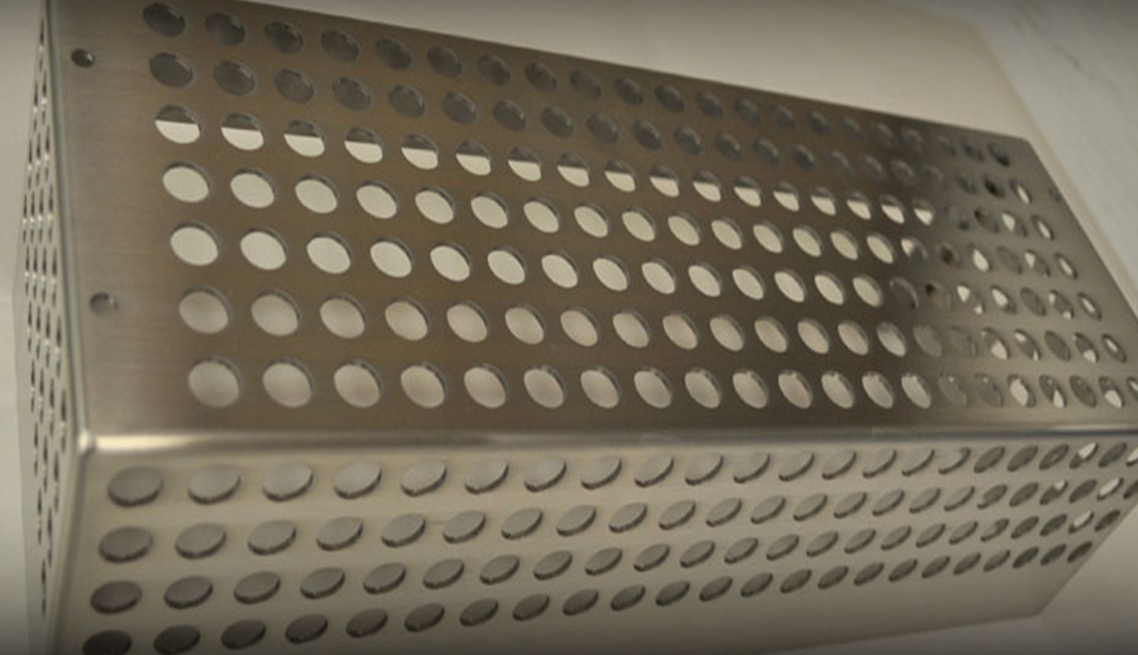 A metal tray with holes in it is sitting on a table.