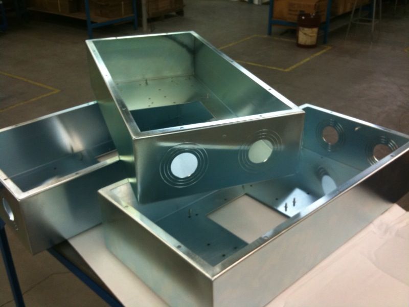 Three metal boxes are stacked on top of each other on a table.