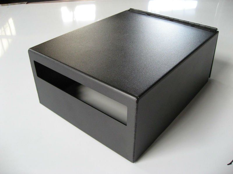 A black box is sitting on a white surface.