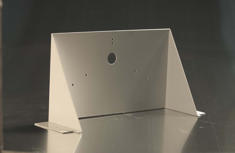 A white box with a hole in the middle is sitting on a table.