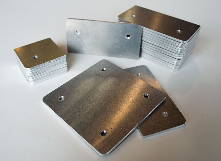 A stack of metal plates with holes in them.