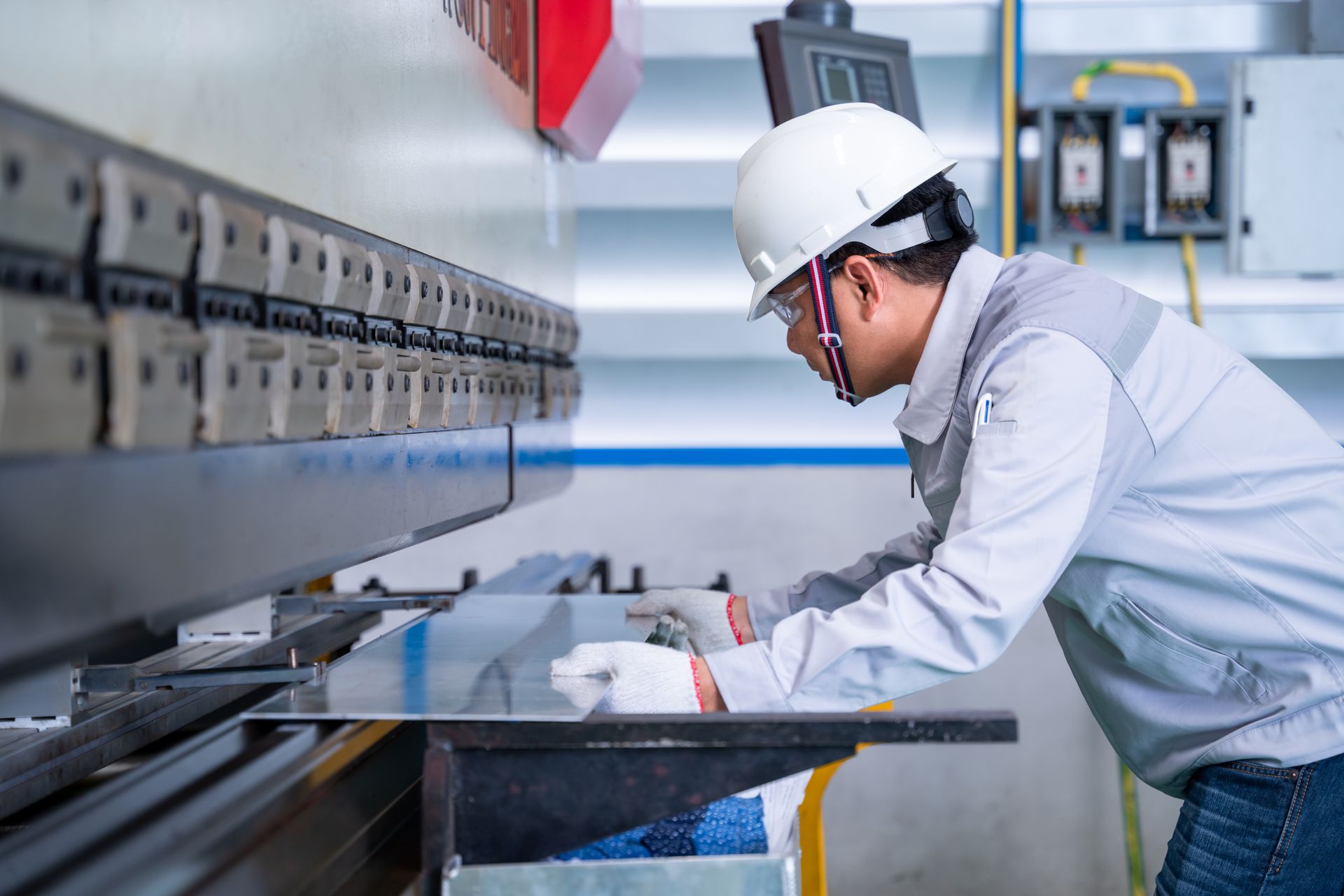 A man is working on a machine in a factory.
