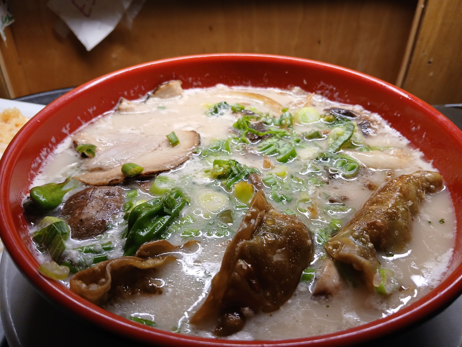 A bowl of soup with meat and vegetables in it