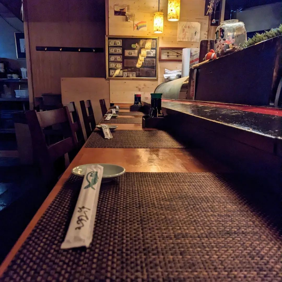 A table in a restaurant with a spoon and chopsticks on it