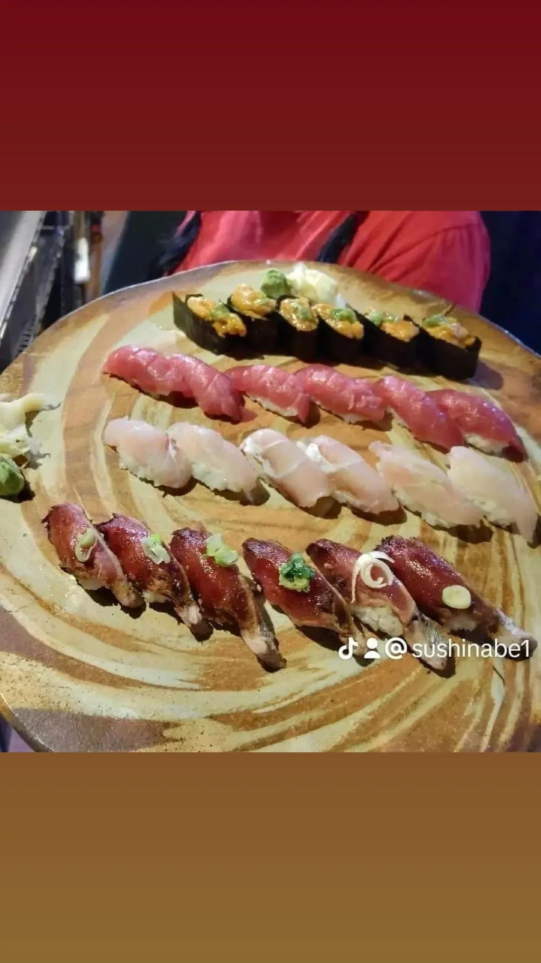 A close up of a plate of sushi on a table.