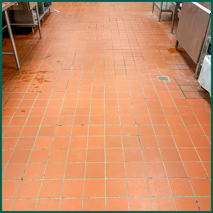 Orange tiled floor in a commercial kitchen or food prep area