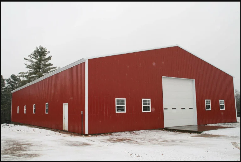 A large red building with a white garage door.