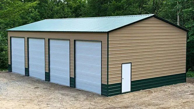a large metal garage with three garage doors and a door