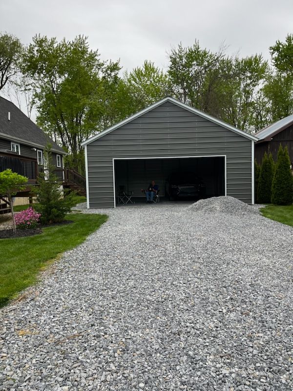 A garage with a gravel driveway