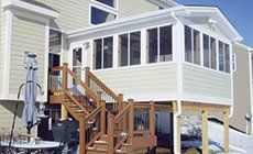 Four Season Sun Room With Wooden Stairs
