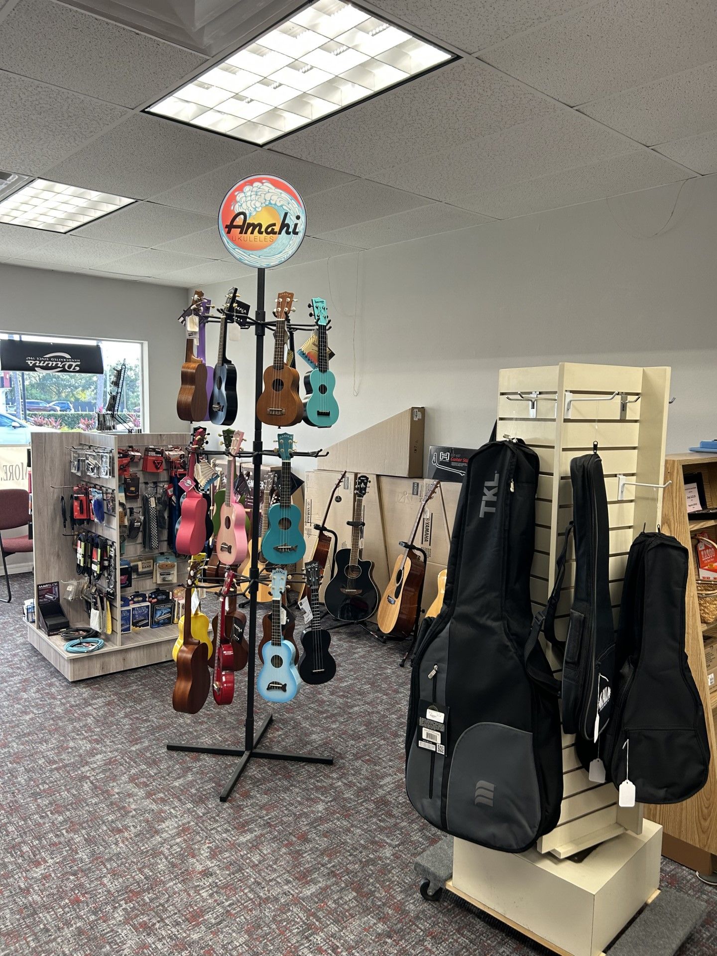 A store filled with lots of guitars and guitar cases.