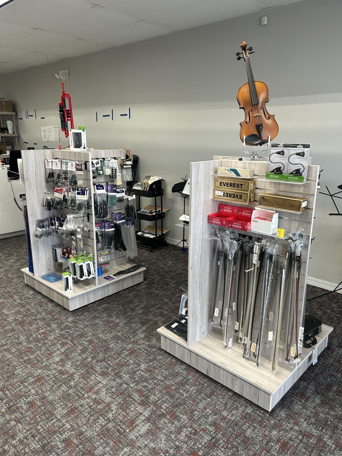 There is a violin hanging on the wall in the middle of the room.